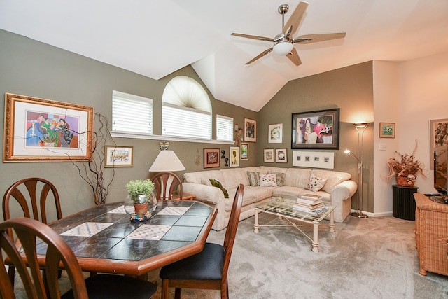 dining area featuring lofted ceiling, a ceiling fan, baseboards, and carpet floors