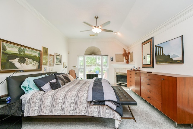 bedroom featuring crown molding, lofted ceiling, a tiled fireplace, and light carpet