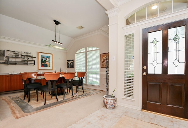 entrance foyer with baseboards, visible vents, lofted ceiling, and crown molding