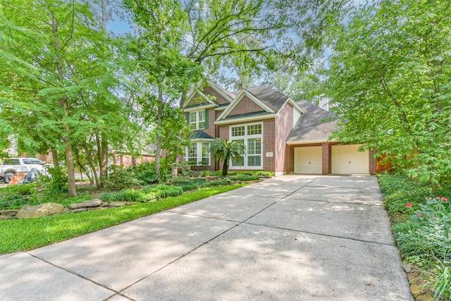 view of front of property featuring brick siding, an attached garage, driveway, and a shingled roof