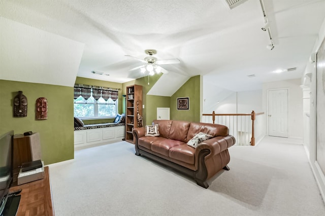 living area with track lighting, visible vents, carpet flooring, baseboards, and a ceiling fan