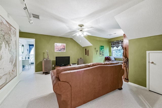 living area with baseboards, ceiling fan, and visible vents