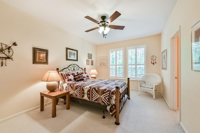 bedroom with light colored carpet, baseboards, and ceiling fan