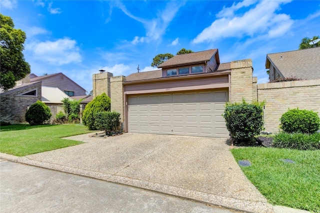 view of front of property with a front yard, an attached garage, and concrete driveway