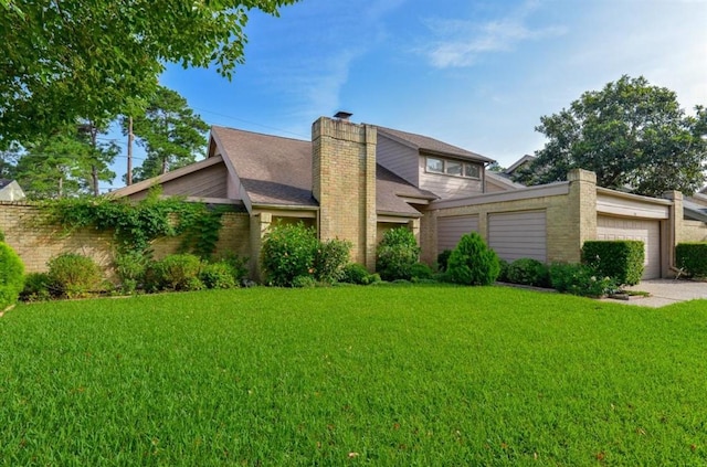 view of front of house featuring driveway, a chimney, a front yard, and a garage