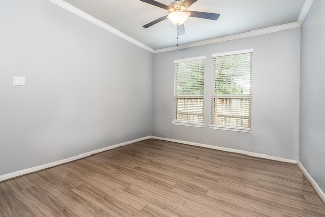 empty room with a ceiling fan, baseboards, ornamental molding, and light wood-type flooring