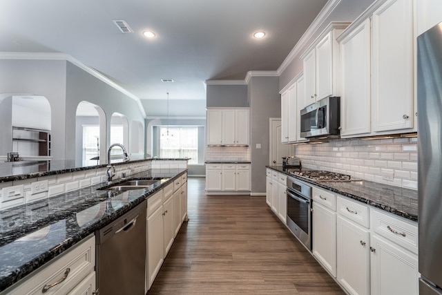 kitchen featuring crown molding, appliances with stainless steel finishes, a sink, white cabinetry, and visible vents