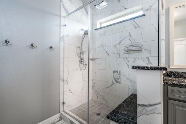 bathroom with vanity, baseboards, visible vents, and a stall shower