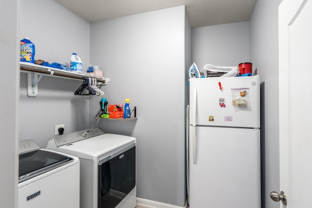 washroom featuring laundry area and washer and dryer