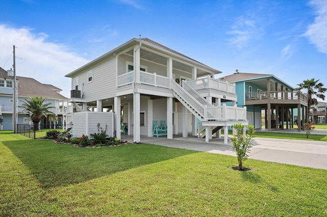 978 Sue Dr, Crystal Beach, TX 77650 - rear view of house with a yard, cooling unit, a carport, stairs, and driveway