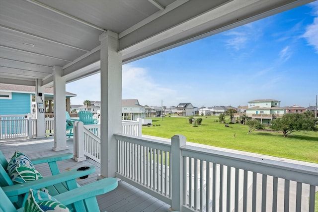 978 Sue Dr, Crystal Beach, TX 77650 - wooden terrace with a lawn, covered porch, and a residential view