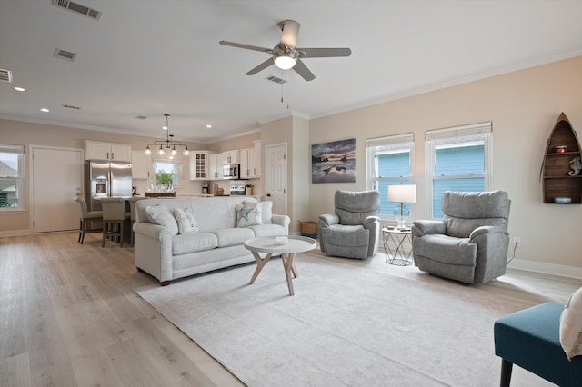 978 Sue Dr, Crystal Beach, TX 77650 - living area with crown molding, visible vents, and ceiling fan with notable chandelier