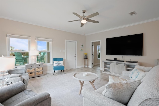 978 Sue Dr, Crystal Beach, TX 77650 - living area featuring ornamental molding, light wood-type flooring, ceiling fan, baseboards, and visible vents