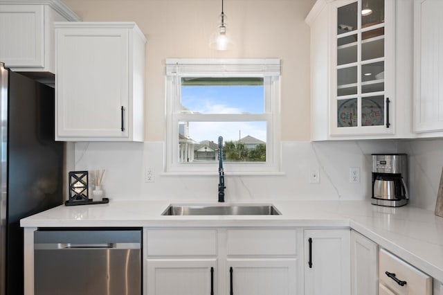 978 Sue Dr, Crystal Beach, TX 77650 - kitchen featuring stainless steel dishwasher, white cabinets, glass insert cabinets, a sink, and light countertops