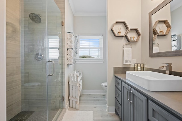 978 Sue Dr, Crystal Beach, TX 77650 - full bathroom featuring wood finished floors, a shower stall, toilet, and vanity