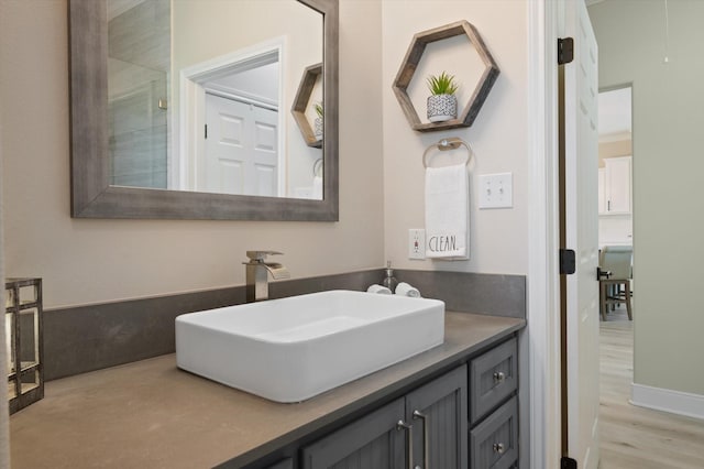 978 Sue Dr, Crystal Beach, TX 77650 - bathroom with wood finished floors and vanity