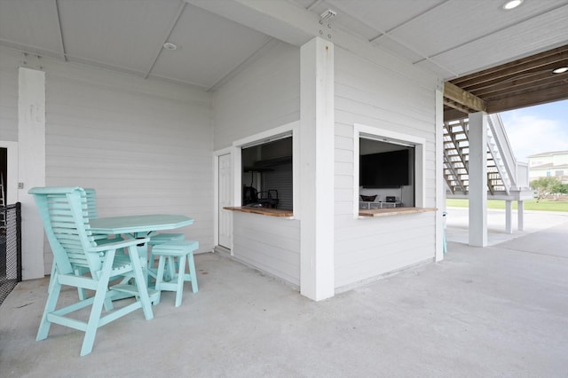 978 Sue Dr, Crystal Beach, TX 77650 - view of patio with stairway and outdoor dining space