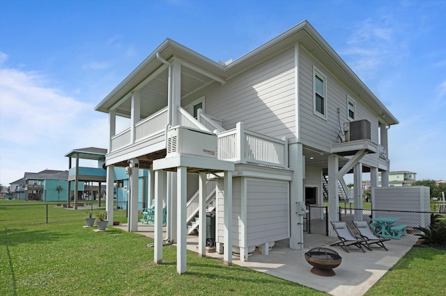 978 Sue Dr, Crystal Beach, TX 77650 - back of property featuring a patio, fence, a yard, and an outdoor fire pit