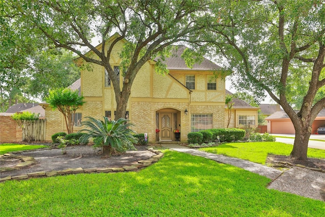 16615 Brendon Ct, Spring, TX 77379 - tudor home with brick siding, fence, and a front yard