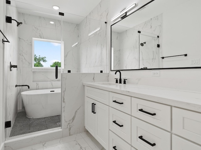 full bathroom with a freestanding tub, a marble finish shower, vanity, and marble finish floor