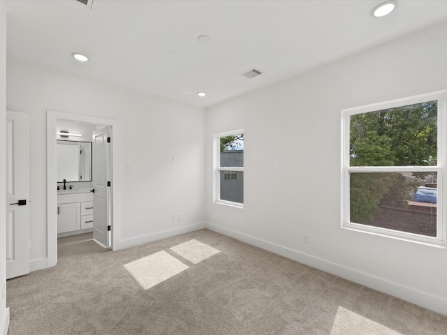 unfurnished bedroom featuring visible vents, baseboards, recessed lighting, and light carpet