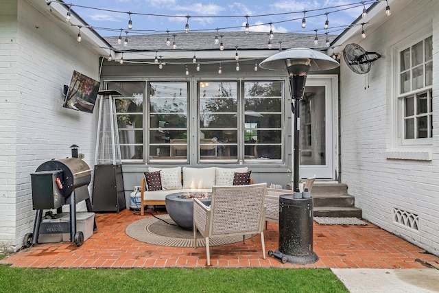 view of patio / terrace featuring entry steps and a fire pit