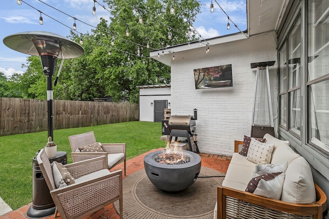 view of patio featuring fence private yard and an outdoor living space with a fire pit