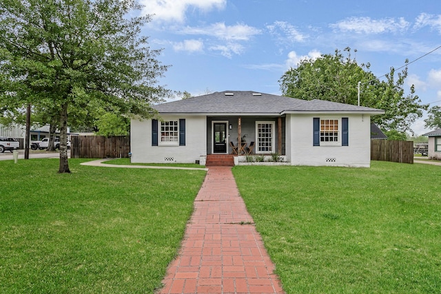 single story home with fence, a front yard, and brick siding