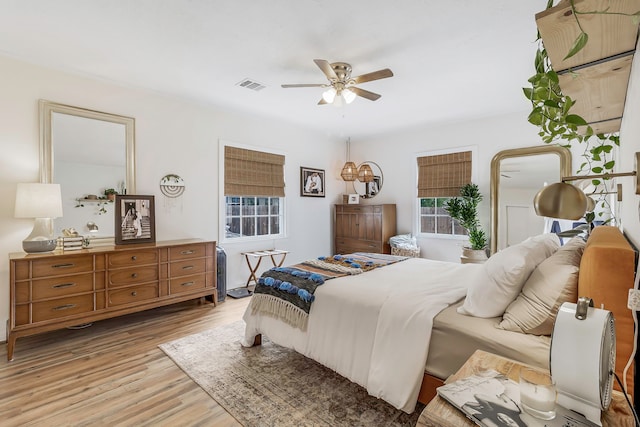 bedroom with visible vents, ceiling fan, and light wood-style flooring