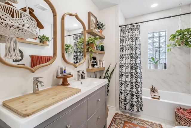 bathroom featuring tile patterned floors, shower / bath combo, visible vents, and vanity
