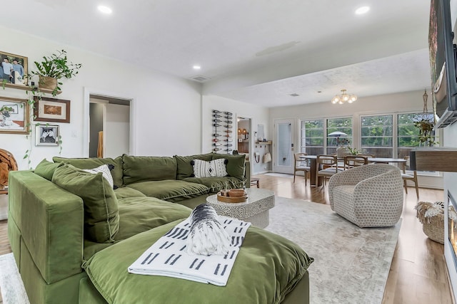 living room with wood finished floors, visible vents, and recessed lighting