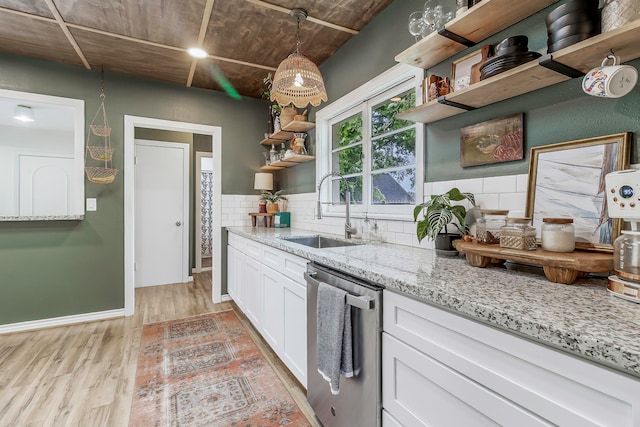 kitchen featuring decorative backsplash, open shelves, light wood-style flooring, a sink, and dishwasher
