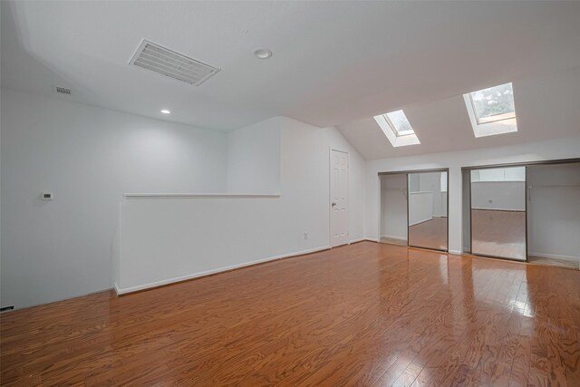 16800 Sugar Pines Dr Unit D28, Houston, TX 77090 - interior space featuring lofted ceiling with skylight, recessed lighting, visible vents, and wood finished floors