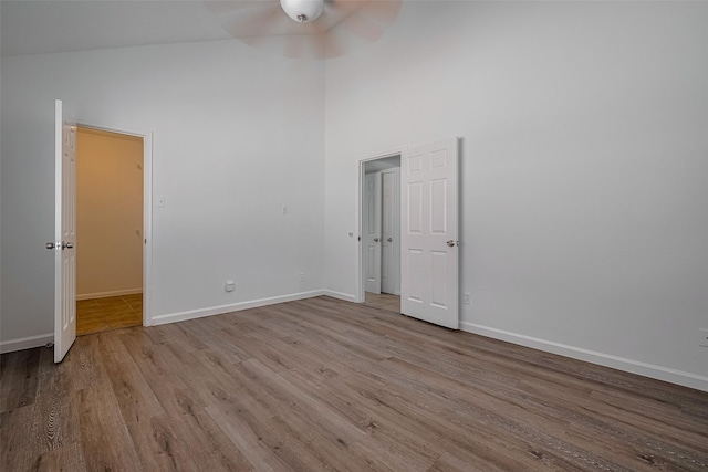 16800 Sugar Pines Dr Unit D28, Houston, TX 77090 - unfurnished bedroom featuring baseboards, high vaulted ceiling, and wood finished floors