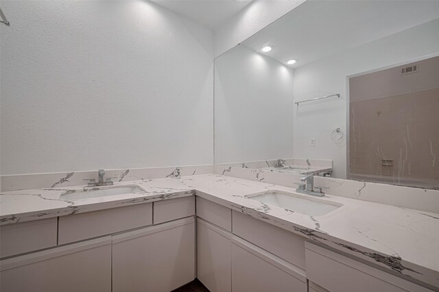 16800 Sugar Pines Dr Unit D28, Houston, TX 77090 - full bathroom with double vanity, visible vents, recessed lighting, and a sink