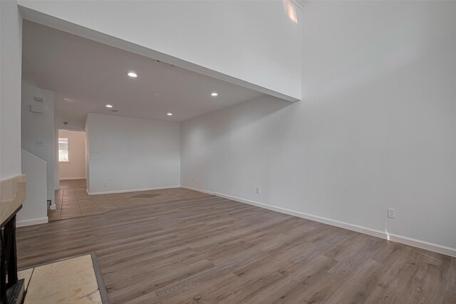 16800 Sugar Pines Dr Unit D28, Houston, TX 77090 - unfurnished living room with baseboards, recessed lighting, and wood finished floors