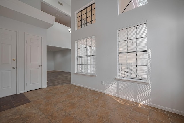 16800 Sugar Pines Dr Unit D28, Houston, TX 77090 - interior space featuring a towering ceiling, visible vents, stone finish flooring, and baseboards