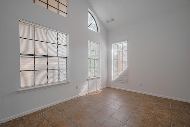 16800 Sugar Pines Dr Unit D28, Houston, TX 77090 - empty room featuring tile patterned floors, baseboards, visible vents, and high vaulted ceiling