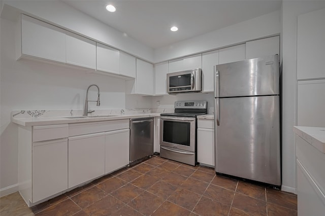 16800 Sugar Pines Dr Unit D28, Houston, TX 77090 - kitchen featuring white cabinetry, stainless steel appliances, light countertops, and a sink