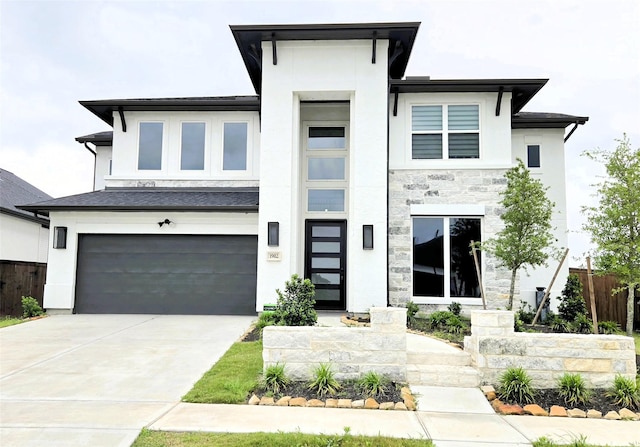 1902 Longcroft Ln, Katy, TX 77493 - view of front facade with fence, stucco siding, an attached garage, stone siding, and driveway