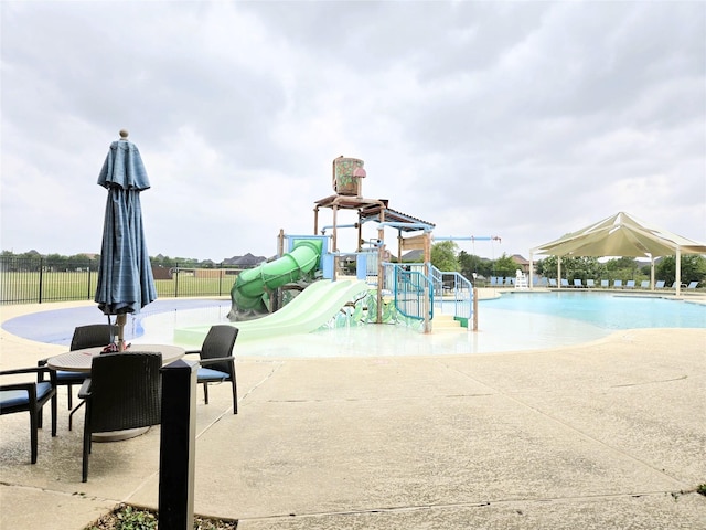 1902 Longcroft Ln, Katy, TX 77493 - community playground featuring fence, a water play area, a community pool, and a patio