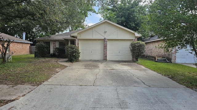 single story home with a front yard, concrete driveway, brick siding, and an attached garage