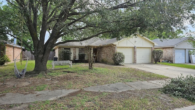 ranch-style house featuring brick siding, fence, driveway, and an attached garage