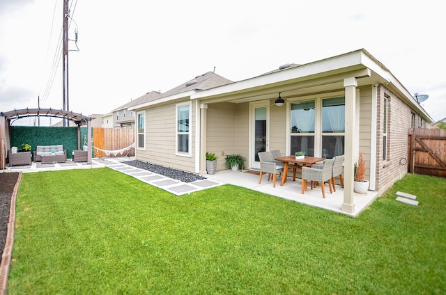 back of house with a fenced backyard, a patio area, a pergola, and an outdoor hangout area