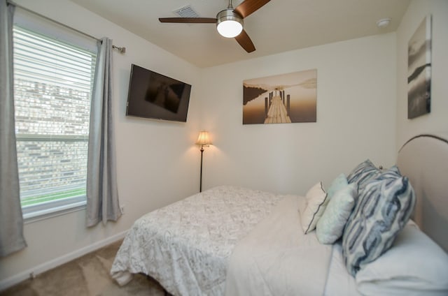 bedroom featuring baseboards, ceiling fan, carpet, and visible vents