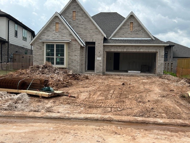 30219 Gold Finch Pl, Fulshear, TX 77441 - view of front of property featuring brick siding and an attached garage