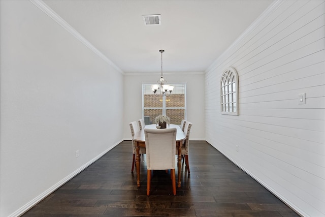 dining area featuring a chandelier, dark wood finished floors, crown molding, and baseboards