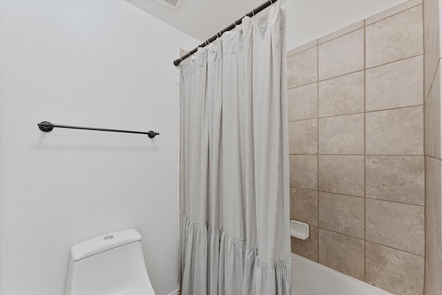 bathroom with toilet and shower / tub combo