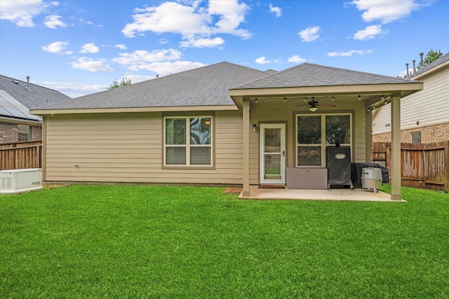 back of house featuring a ceiling fan, a patio area, and a shingled roof