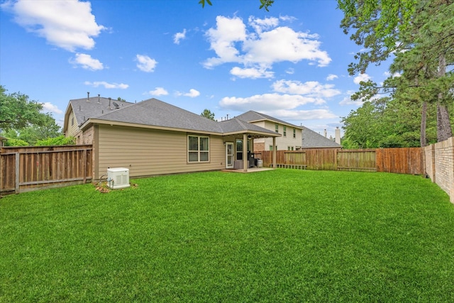 rear view of property featuring a patio and a shingled roof